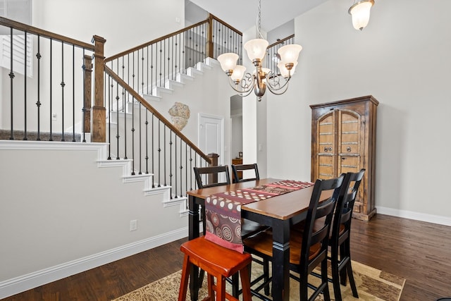 dining room featuring baseboards, a notable chandelier, and wood finished floors