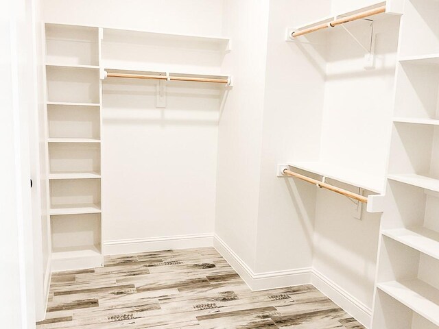 spacious closet with wood finished floors