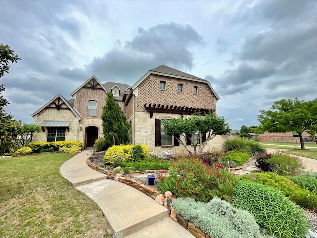 french provincial home featuring stone siding and a front lawn