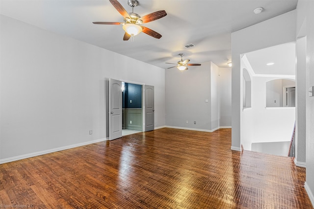unfurnished living room featuring baseboards, visible vents, ceiling fan, and wood finished floors