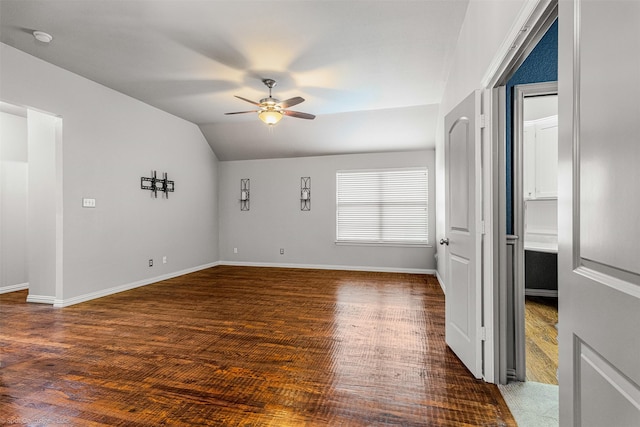 unfurnished living room with baseboards, wood finished floors, ceiling fan, and vaulted ceiling