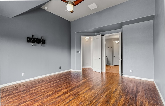 unfurnished bedroom featuring baseboards, visible vents, ceiling fan with notable chandelier, high vaulted ceiling, and wood finished floors