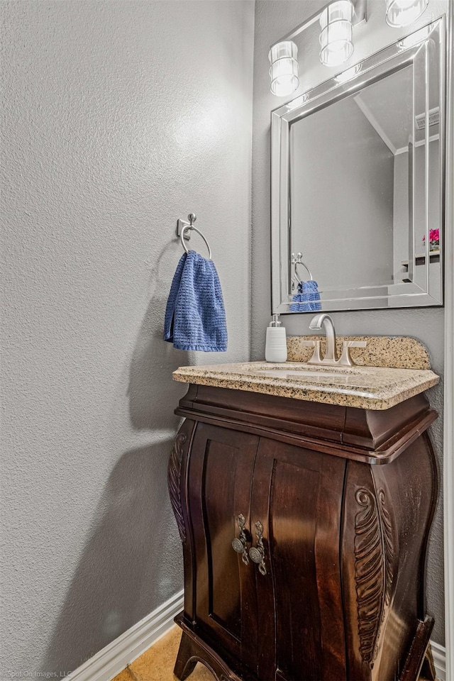 bathroom with vanity and a textured wall