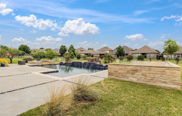 view of pool featuring a yard, a residential view, and fence