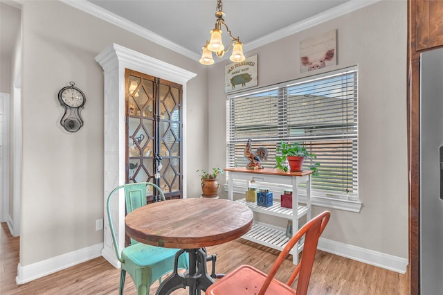 dining area with baseboards, light wood-style floors, and french doors