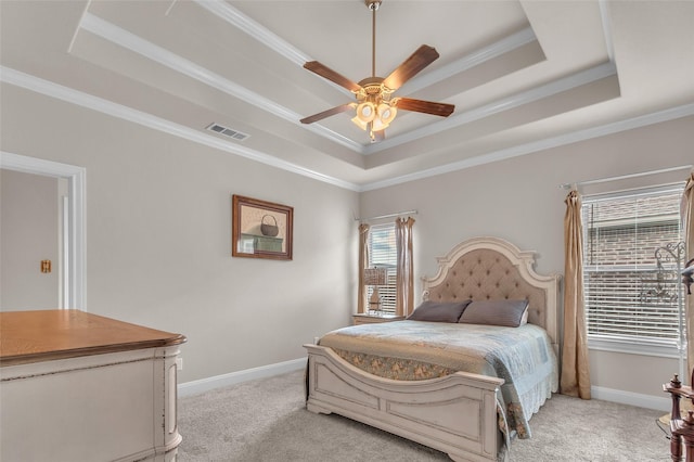 bedroom with ornamental molding, a raised ceiling, visible vents, and light carpet