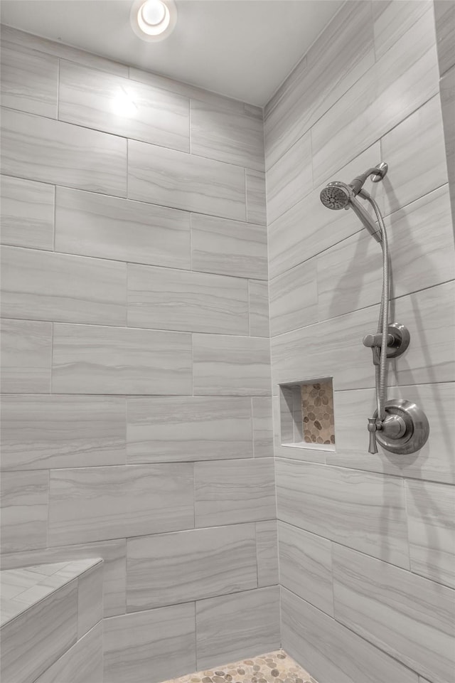 full bath with a tile shower