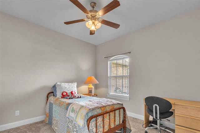 carpeted bedroom featuring baseboards and a ceiling fan