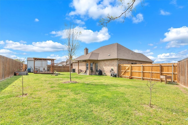 view of yard featuring central AC unit and a fenced backyard