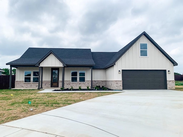 208 Bluff Ct, Godley, TX 76044 - modern farmhouse style home with board and batten siding, roof with shingles, a front yard, and concrete driveway