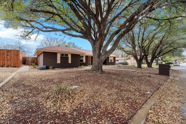 ranch-style home with fence