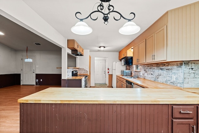 kitchen with wood counters, wood finished floors, appliances with stainless steel finishes, and decorative backsplash