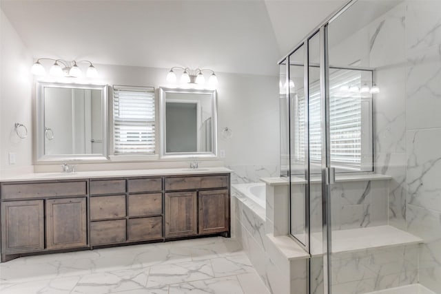 full bath featuring a garden tub, double vanity, marble finish floor, a sink, and a marble finish shower
