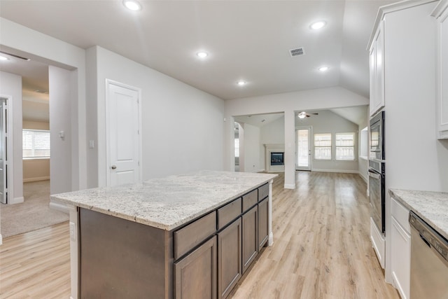 kitchen featuring visible vents, light wood-type flooring, white cabinetry, a ceiling fan, and appliances with stainless steel finishes
