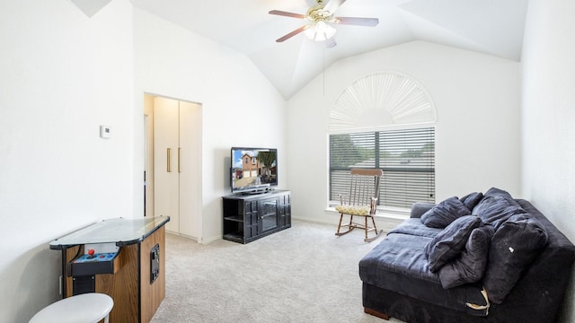 living area featuring ceiling fan, light carpet, baseboards, and lofted ceiling