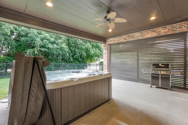 view of patio featuring a hot tub, ceiling fan, and fence