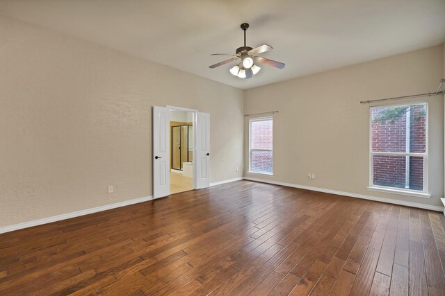 9405 National Pines Dr, Mckinney, TX 75072 - empty room featuring plenty of natural light, a ceiling fan, baseboards, and hardwood / wood-style floors