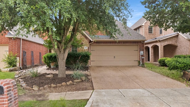 9405 National Pines Dr, Mckinney, TX 75072 - view of front of house featuring brick siding, a garage, and concrete driveway