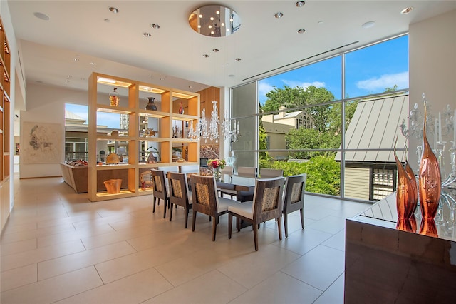 dining space featuring a wealth of natural light, tile patterned flooring, and expansive windows