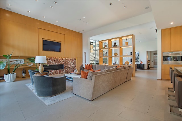 living room with recessed lighting, light tile patterned floors, and a fireplace