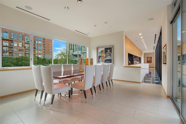 dining space featuring recessed lighting, tile patterned flooring, and baseboards