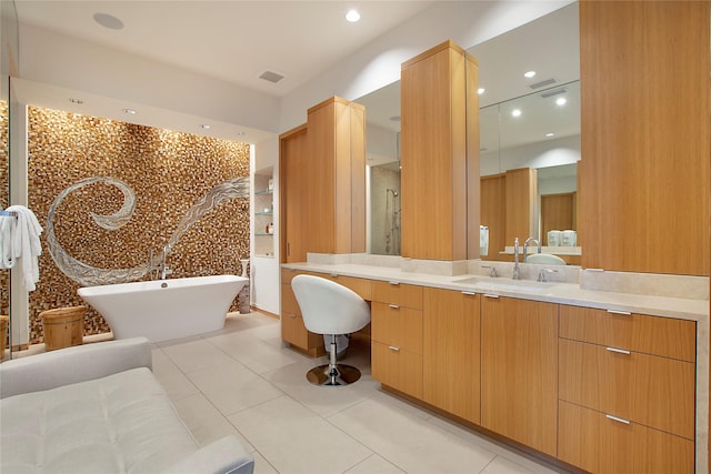 bathroom with a shower stall, a soaking tub, visible vents, vanity, and tile patterned flooring