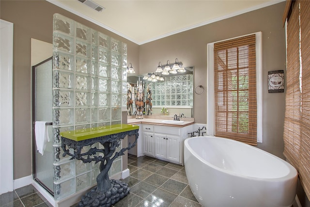 bathroom with a freestanding tub, ornamental molding, vanity, visible vents, and a stall shower