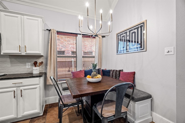 dining room featuring a chandelier, ornamental molding, and baseboards