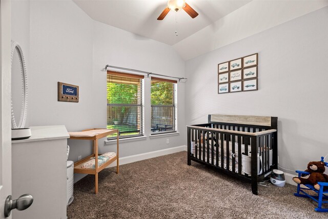 bedroom with lofted ceiling, baseboards, a crib, carpet, and a ceiling fan