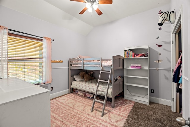 bedroom with ceiling fan, carpet flooring, vaulted ceiling, and baseboards