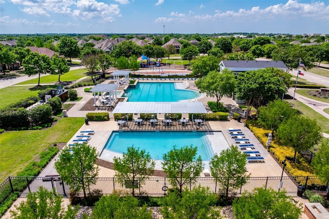 view of swimming pool featuring fence