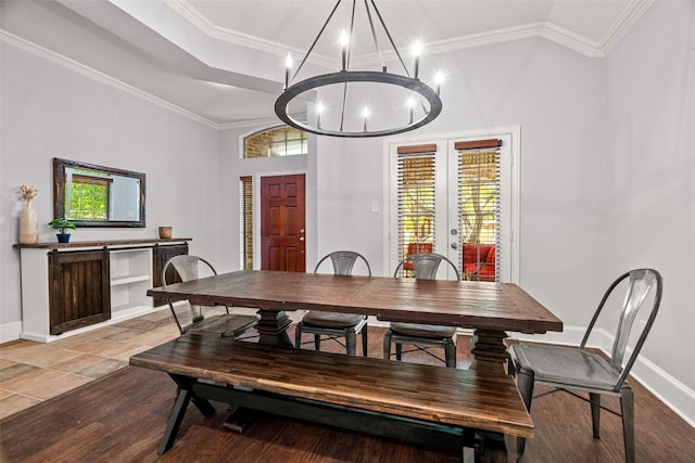 dining space with crown molding, french doors, a chandelier, and baseboards