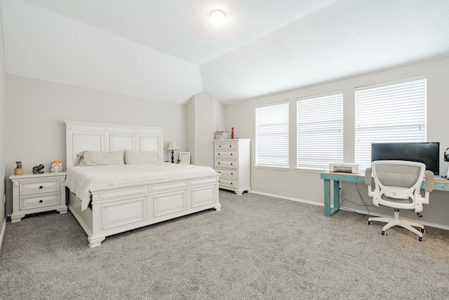 bedroom with vaulted ceiling, light carpet, and baseboards