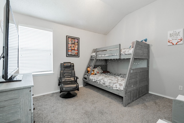 carpeted bedroom featuring multiple windows, lofted ceiling, and baseboards