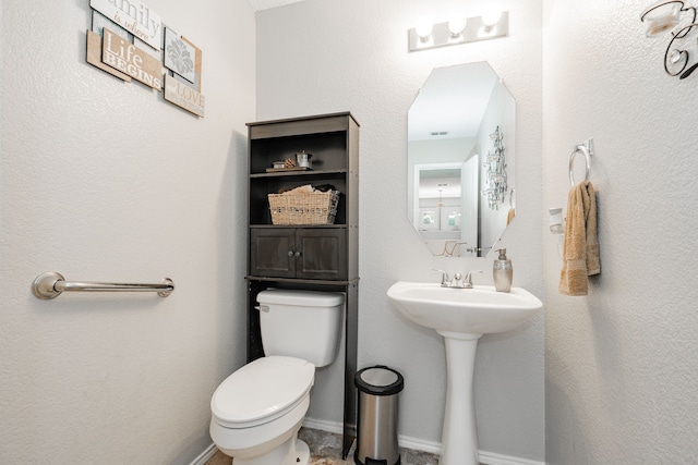 bathroom featuring toilet and a sink