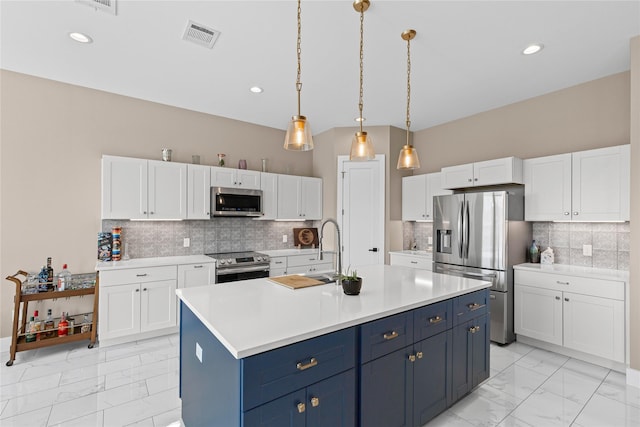 kitchen featuring marble finish floor, white cabinets, and stainless steel appliances