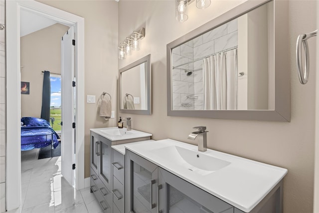 bathroom featuring two vanities, ensuite bathroom, marble finish floor, and a sink