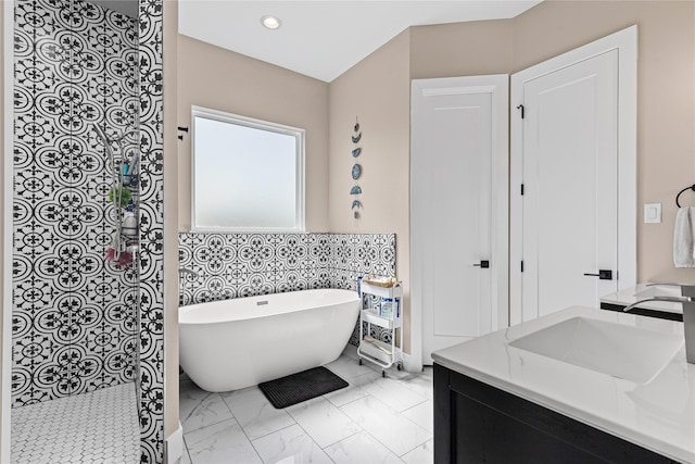 bathroom with a shower, recessed lighting, a freestanding tub, vanity, and marble finish floor