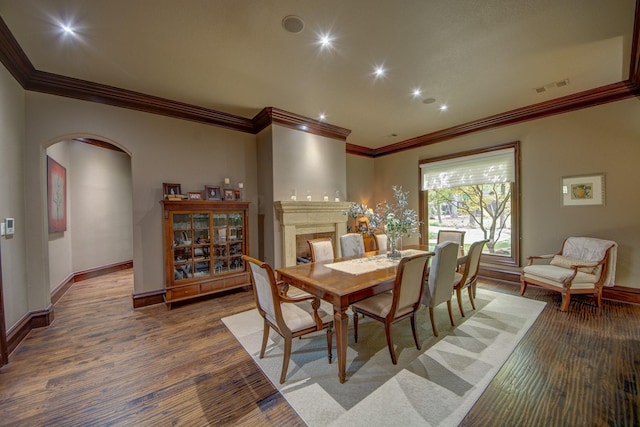 9 Victory Ln, Double Oak, TX 75077 - dining space featuring arched walkways, ornamental molding, wood finished floors, recessed lighting, and baseboards