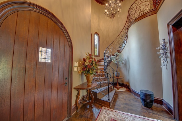 9 Victory Ln, Double Oak, TX 75077 - foyer with wood finished floors, arched walkways, baseboards, a chandelier, and a towering ceiling
