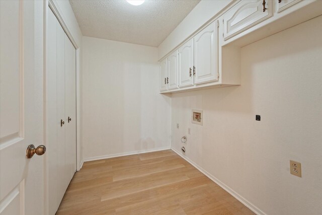 washroom with gas dryer hookup, electric dryer hookup, cabinet space, hookup for a washing machine, and light wood-style floors