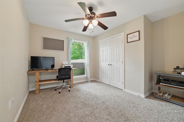 office space featuring a ceiling fan, carpet flooring, and baseboards