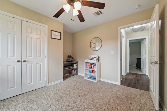 interior space with a closet, visible vents, carpet, and baseboards