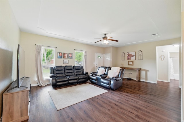 living area with ceiling fan, visible vents, dark wood finished floors, and baseboards