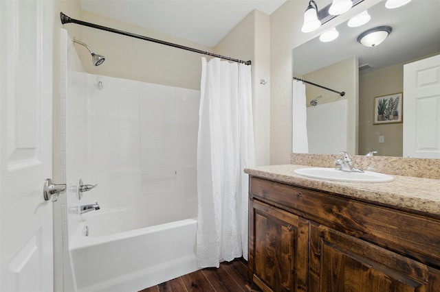 bathroom with shower / bath combo, wood finished floors, and vanity