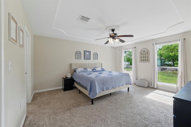 carpeted bedroom featuring baseboards, visible vents, access to exterior, and ceiling fan