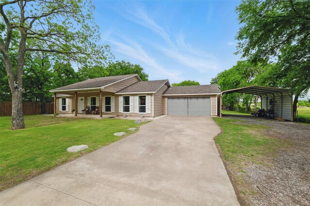 ranch-style house featuring fence, a carport, driveway, a front yard, and an attached garage