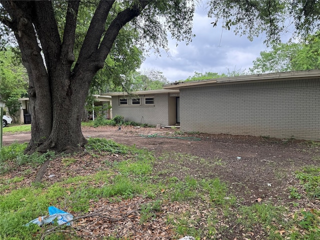 exterior space featuring brick siding