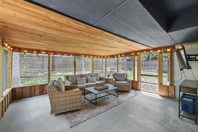 living room with ceiling fan, a fireplace, french doors, vaulted ceiling with beams, and wood finished floors