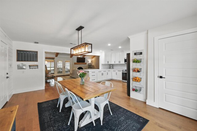 dining room with recessed lighting, visible vents, french doors, and light wood-type flooring